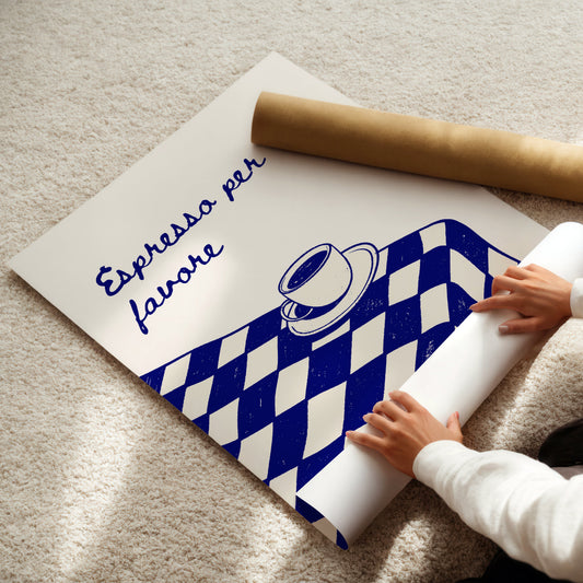 Person unrolling a poster with a coffee-themed design on a light-colored floor.