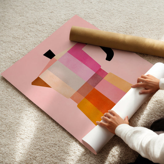 Person unrolling a colorful poster on a light-colored floor
