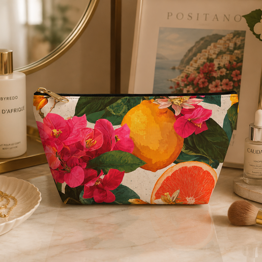 Floral citrus pouch on a vanity table with skincare products.