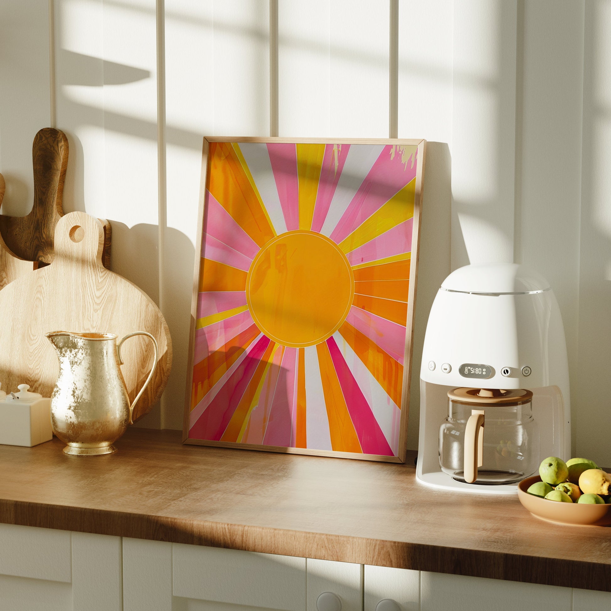 Kitchen counter with a coffee machine, colorful sun painting, and fruit bowl.