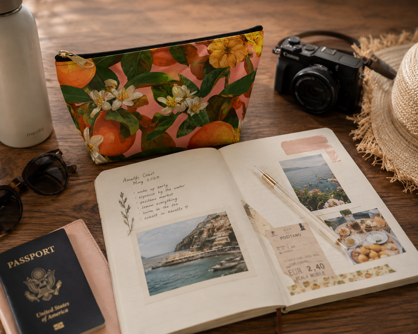 Open travel journal with photos and passport on a wooden surface with a floral orange blossom pouch.