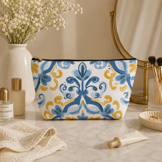 Cosmetic bag with decorative pattern on a vanity table with beauty products.