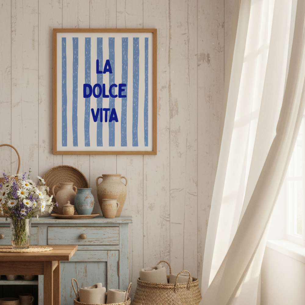Room interior with a 'La Dolce Vita' framed print, wicker baskets, and a wooden table.