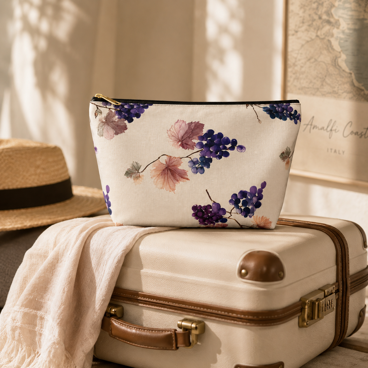 Floral-patterned pouch on a suitcase with a hat and travel guidebook in the background