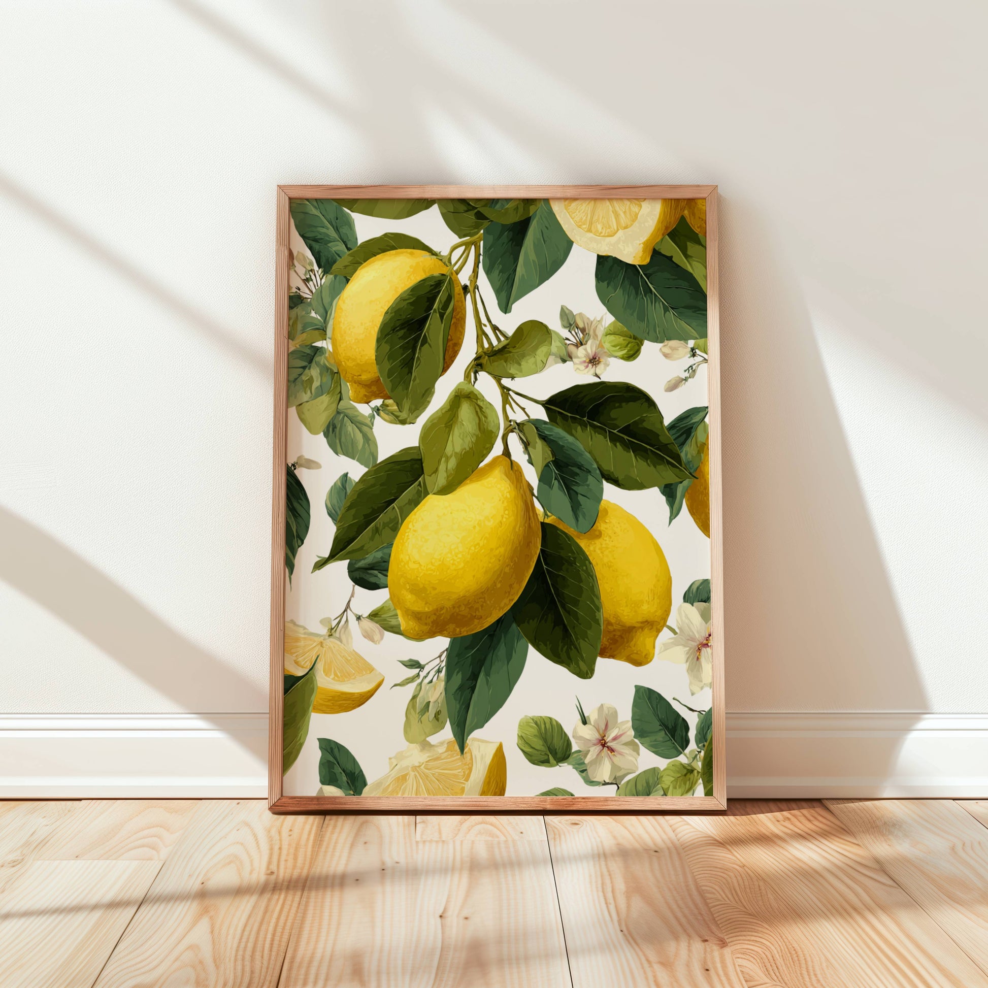 Framed artwork of lemons and leaves on a white wall.