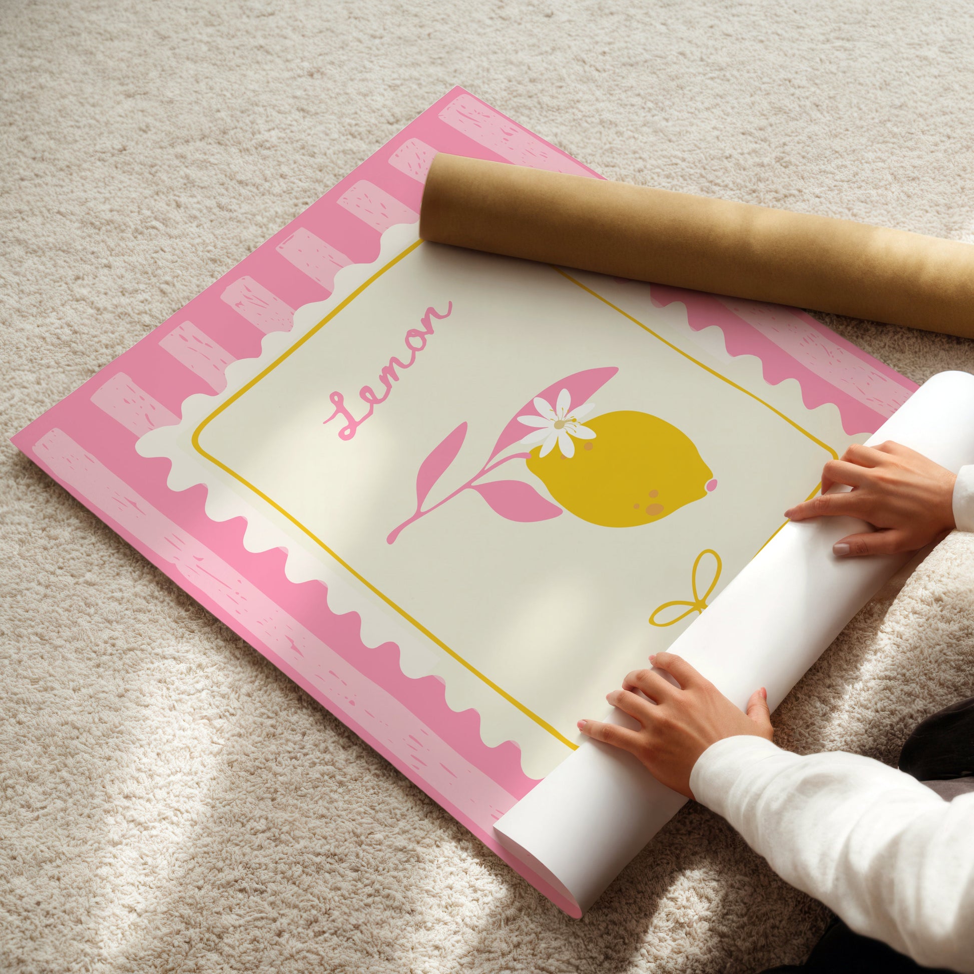 Person unrolling a decorative paper with a lemon design on a carpeted floor.