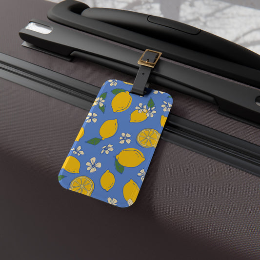 Luggage tag with lemon pattern attached to a suitcase