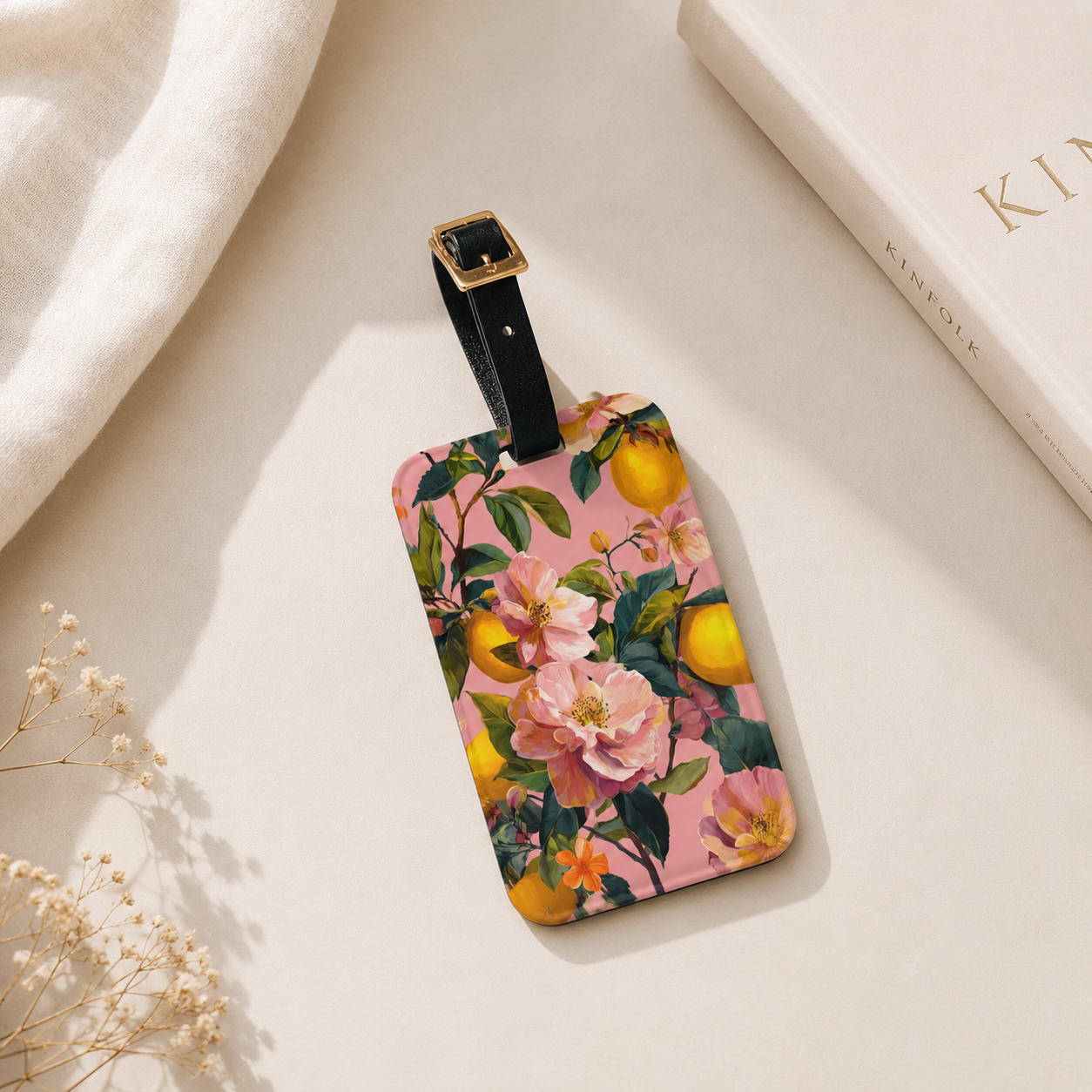 Floral and fruit patterned luggage tag on a light background