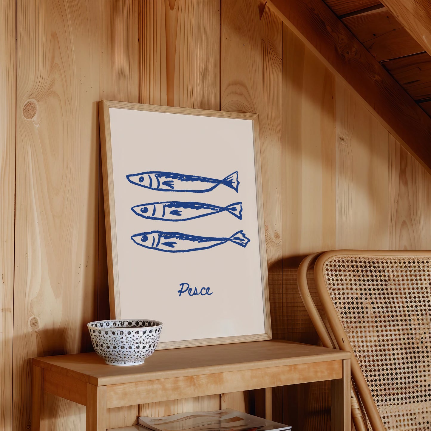 Framed artwork with blue fish illustrations and 'Pesce' text on a wooden shelf.