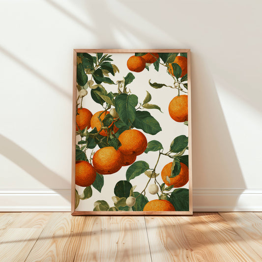 Framed artwork of oranges on a branch against a white wall.