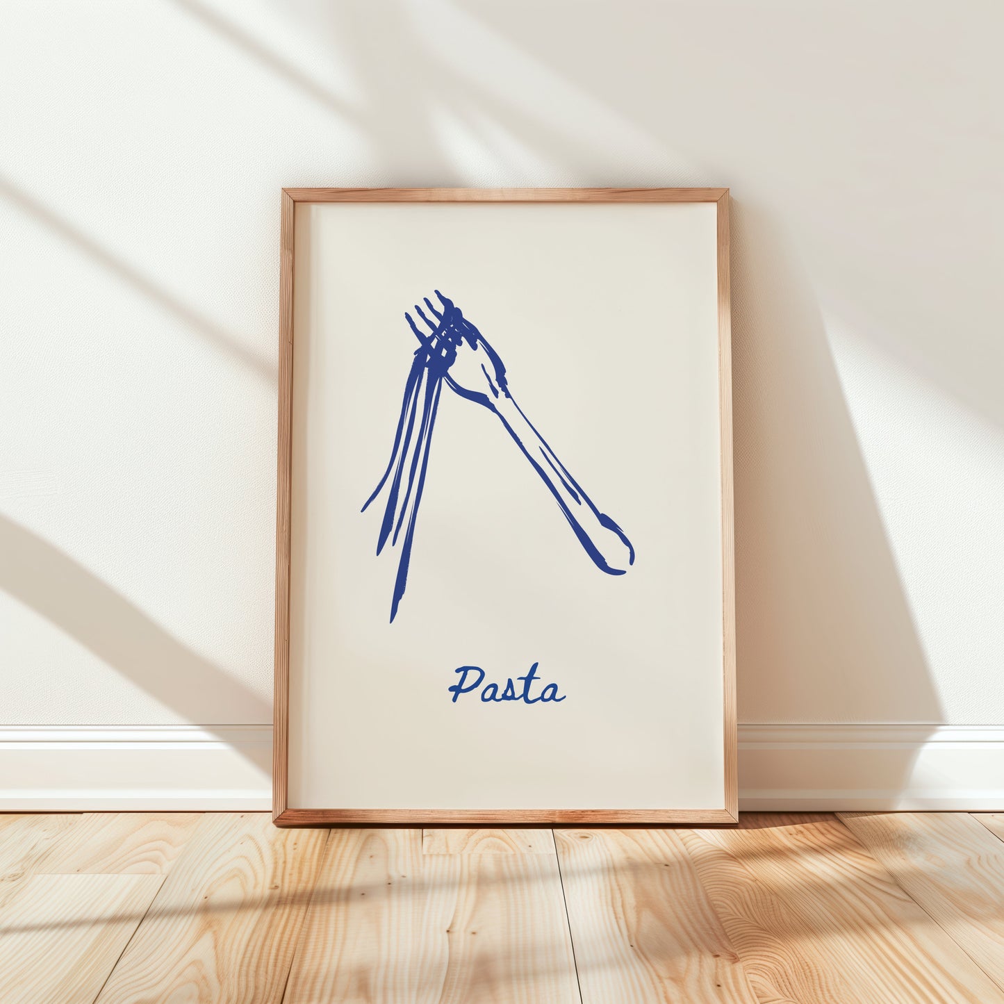 Framed artwork of a blue pasta illustration on a white wall.