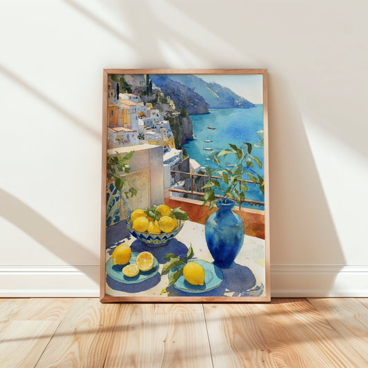 Framed artwork of Italian coastal scene with lemons and a vase on a table, displayed on a wall.