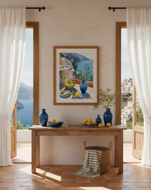 Dining room with wooden table, decorative vases, and a large framed painting of a coastal Positano scene.