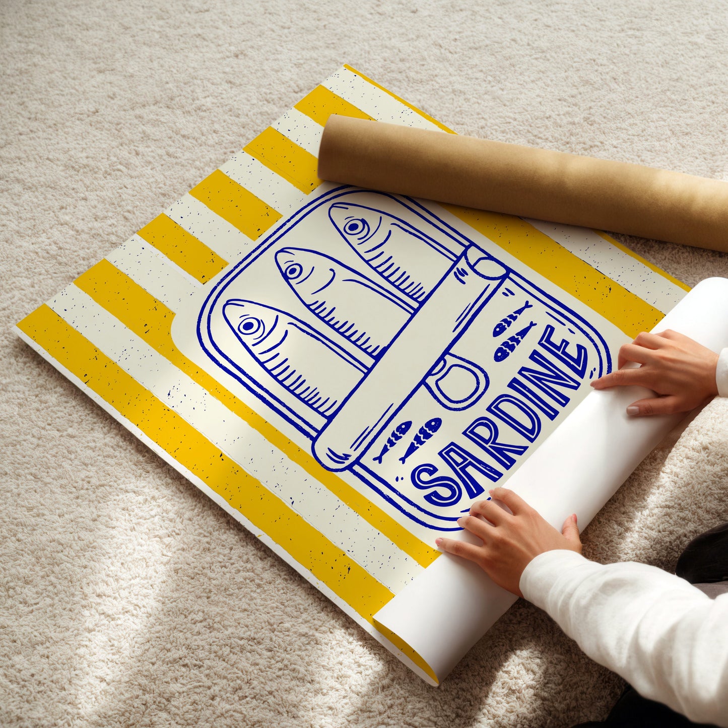 Person unrolling a poster with 'Sardine' print on a carpeted floor.