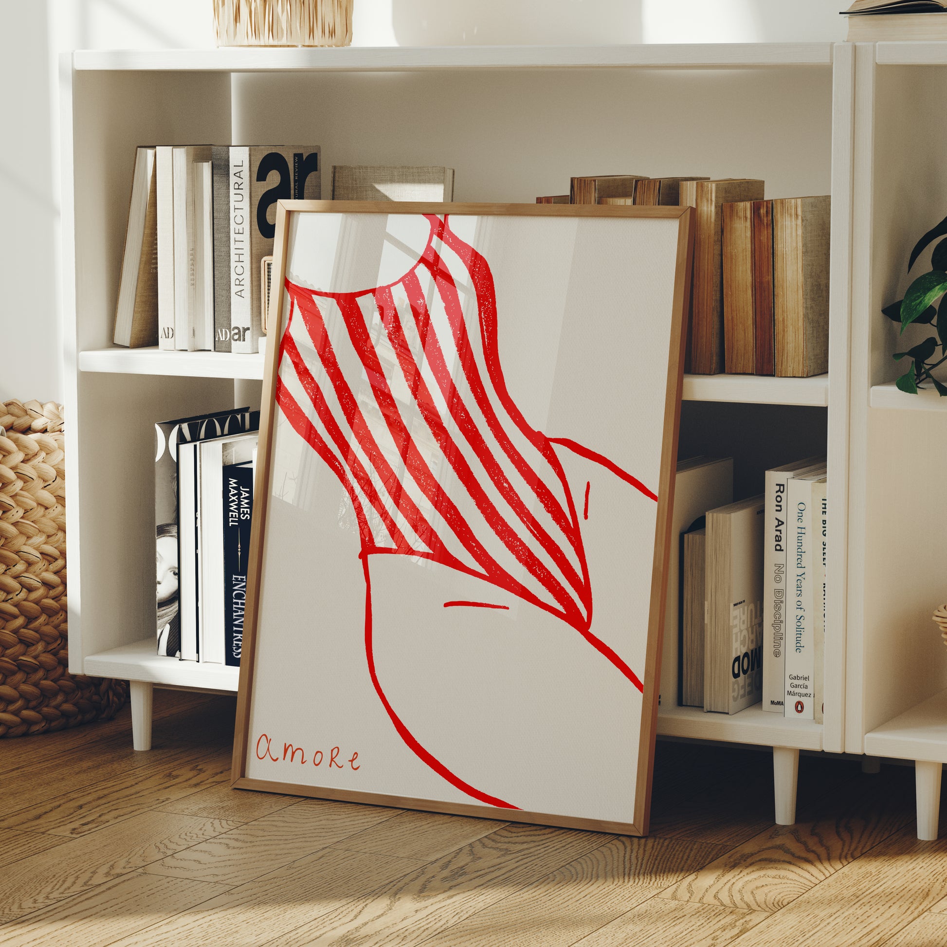 Framed artwork of a red and white Swimsuit with amore on a bookshelf background