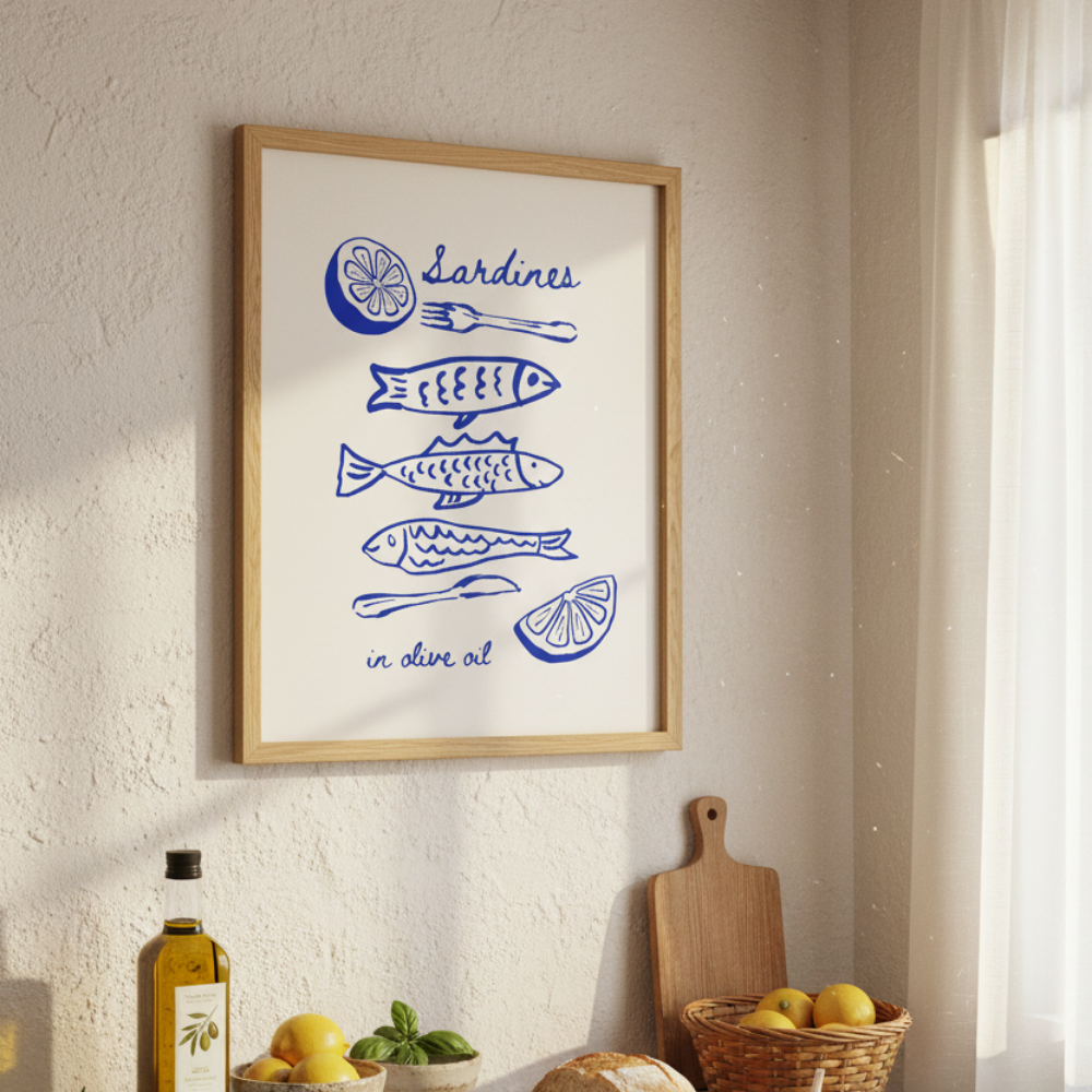 Framed artwork with blue illustrations on a wall above a kitchen counter with food items.