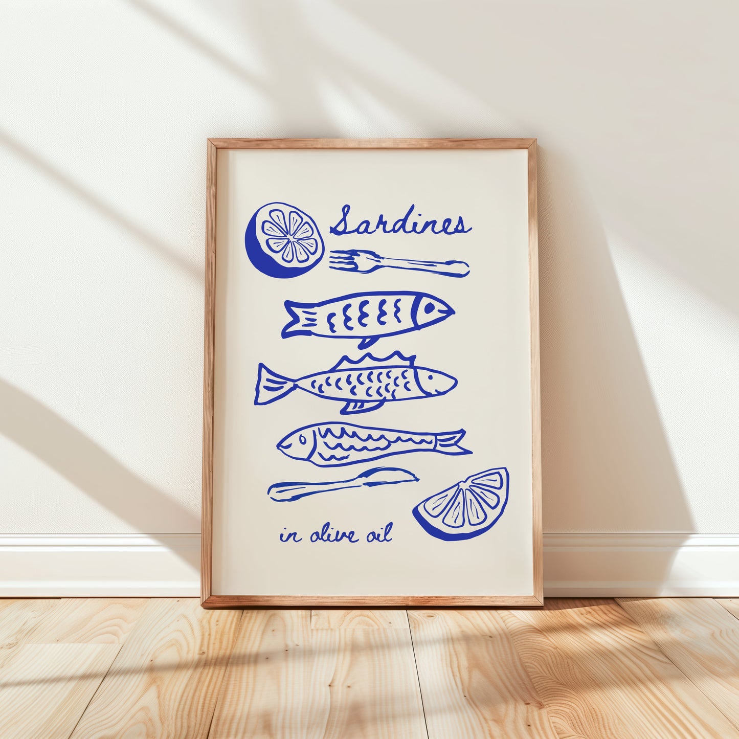 Framed artwork with blue sardine fish illustrations and text on a white wall.