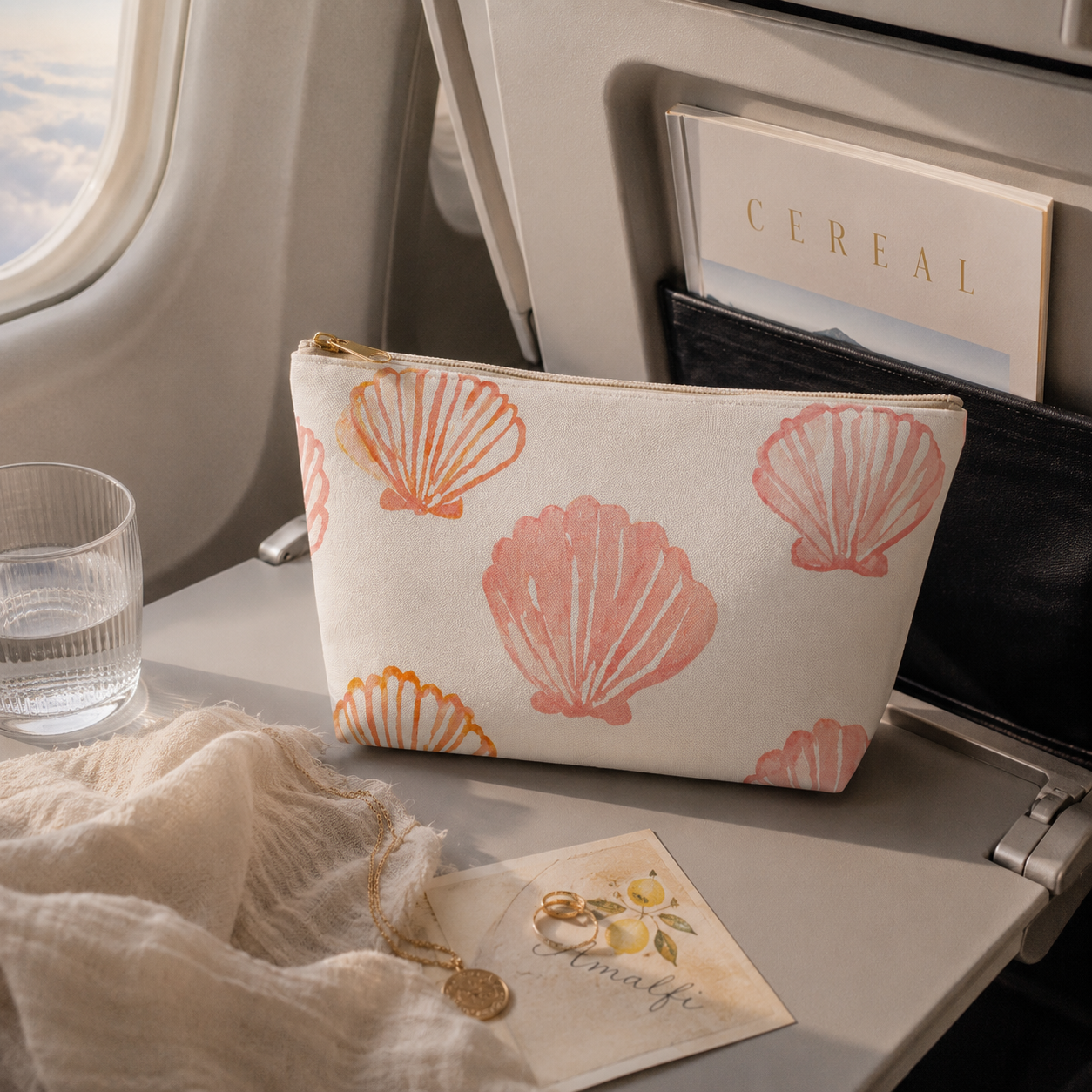 Cosmetic bag with shell pattern on airplane tray table