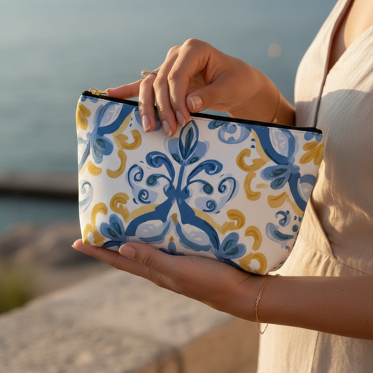 Person holding a patterned pouch by the beach