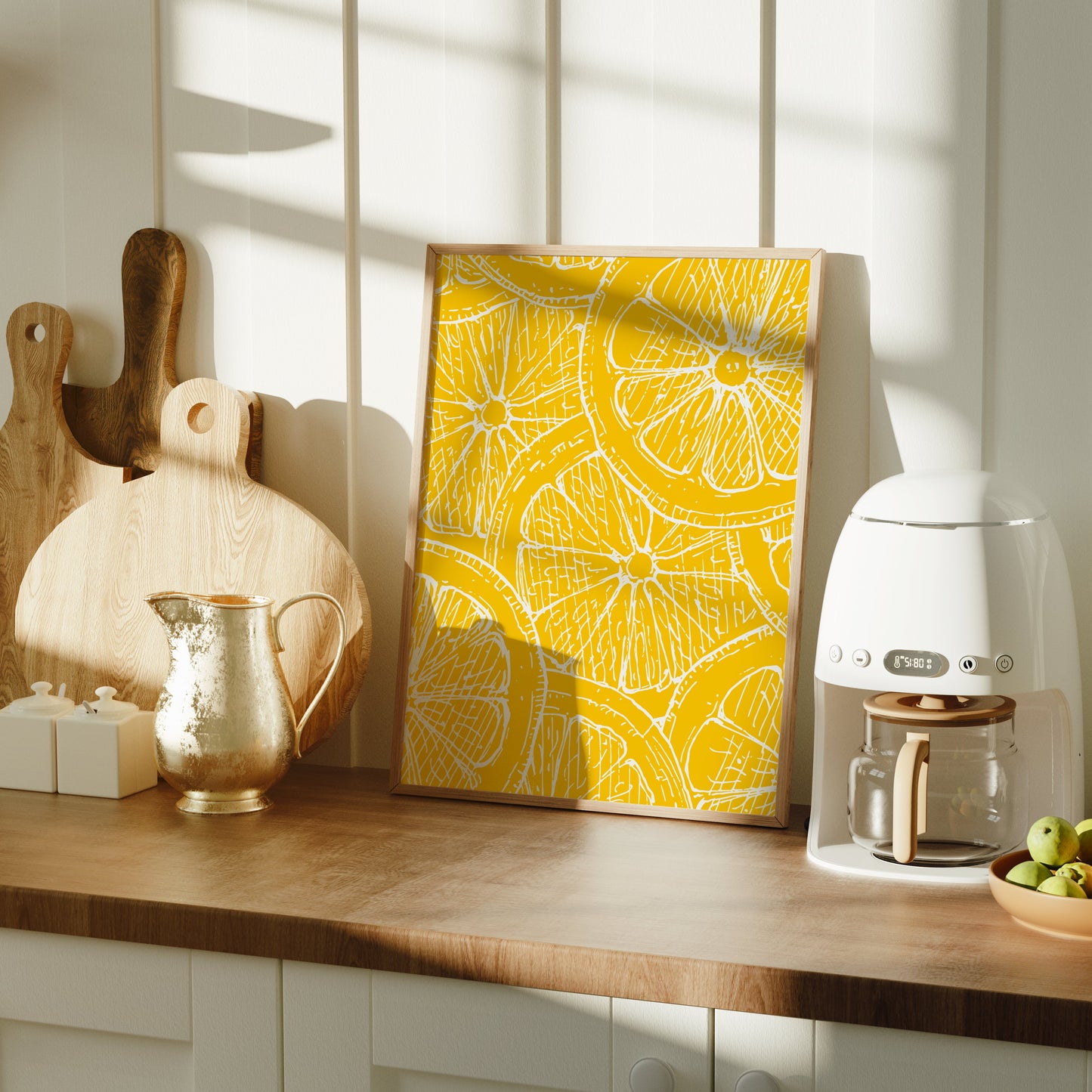 Kitchen counter with a coffee machine, cutting boards, and a yellow lemon art print.