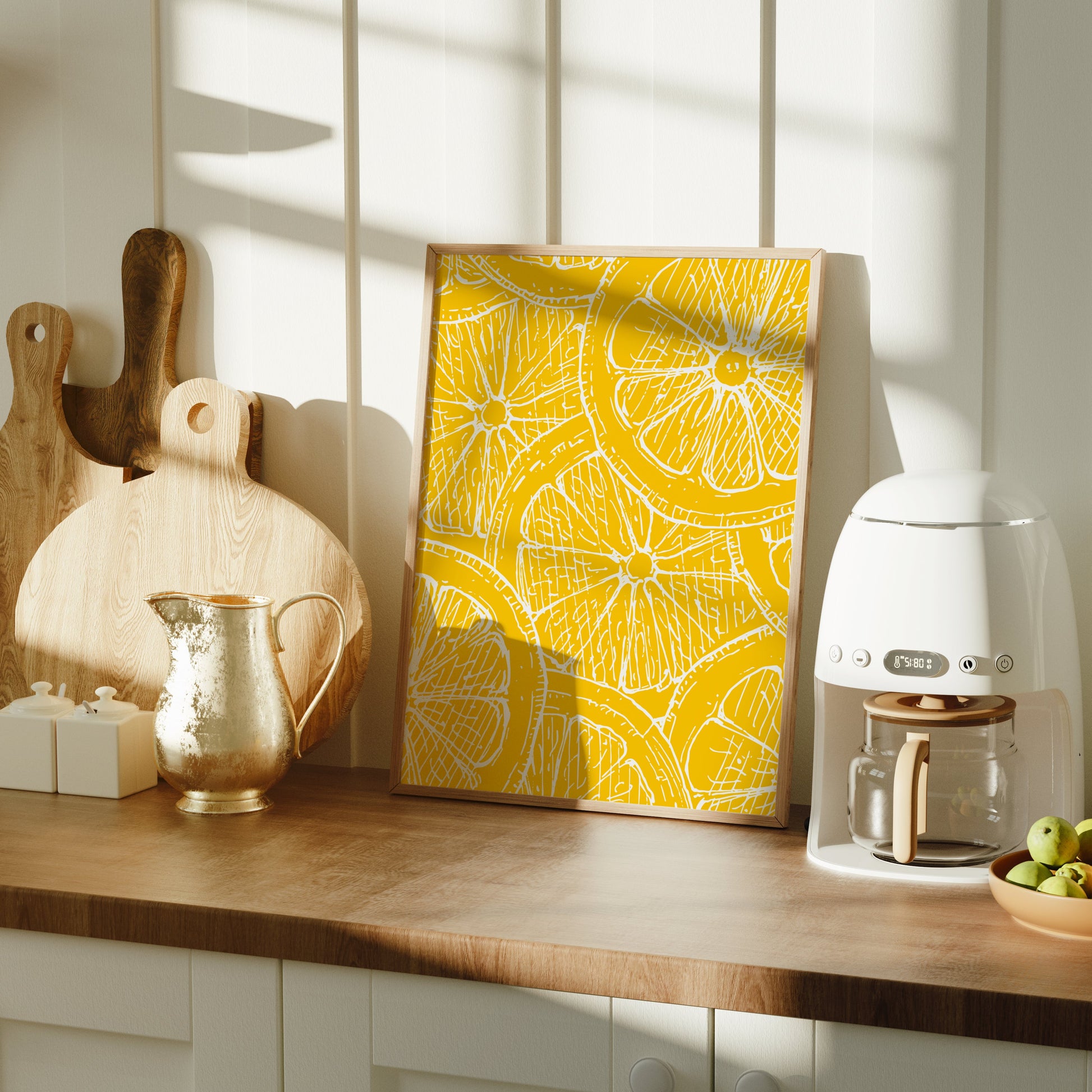 Kitchen counter with a coffee machine, cutting boards, and a yellow lemon art print.
