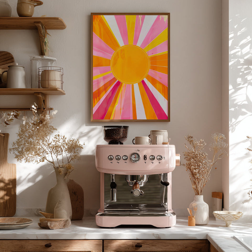 Pink espresso machine on a kitchen counter with a colorful abstract  sun painting above.