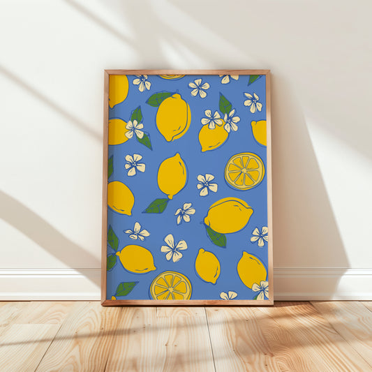 Framed artwork with lemon pattern on a blue background in a room with wooden floor and white walls.