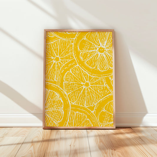 Framed artwork with a yellow and white pattern of lemon slices on a white wall.