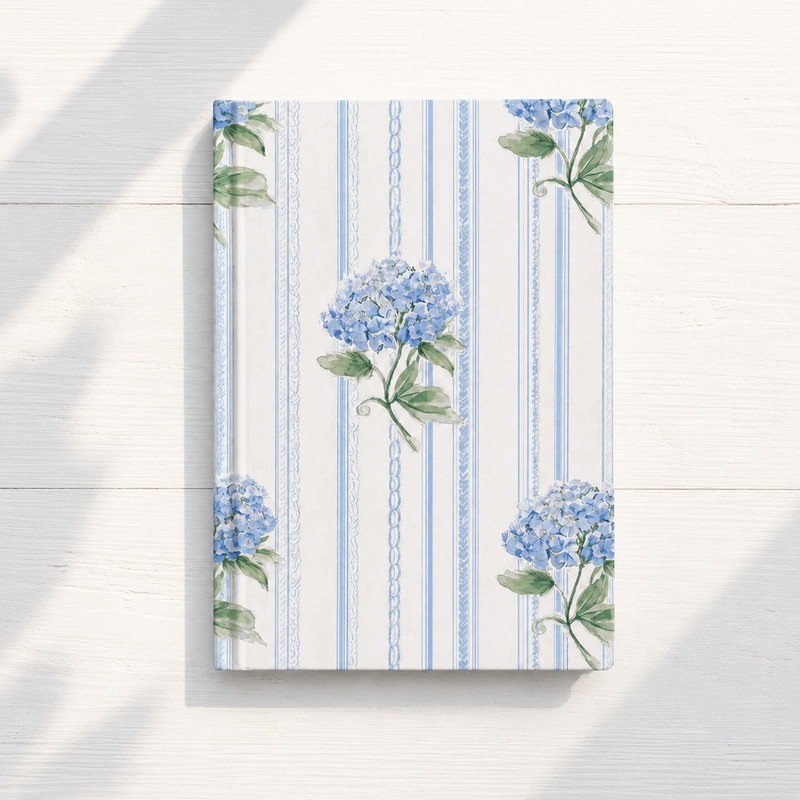 Notebook with blue hydrangea floral design on a striped background