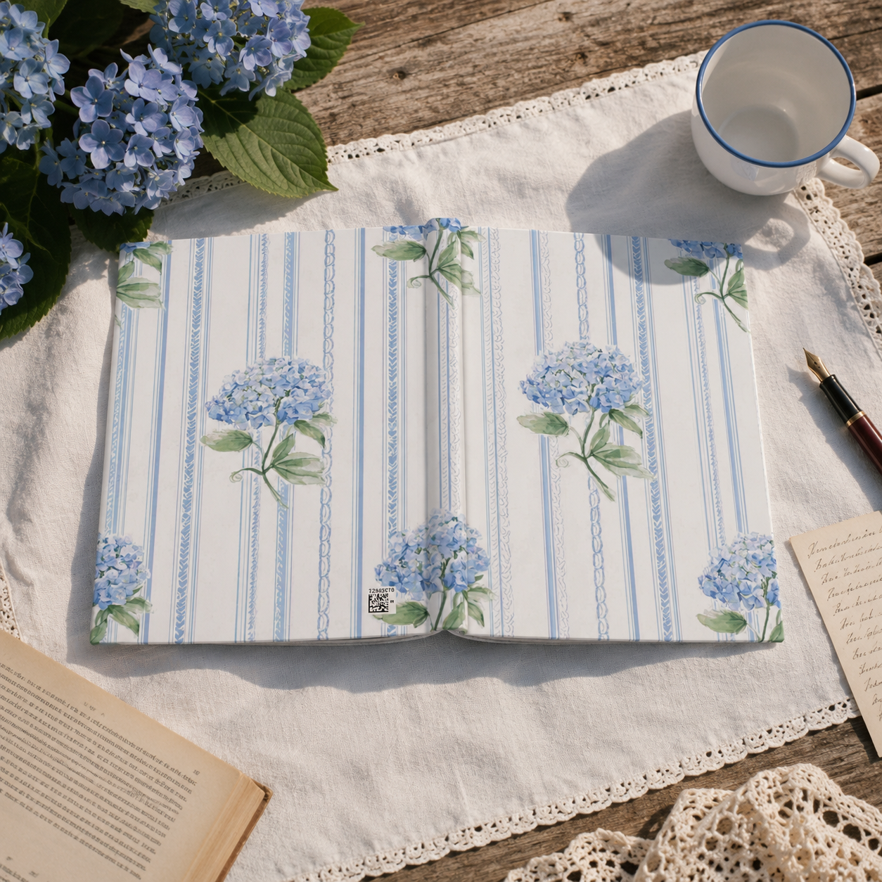 Open hydrangea journal displayed in a cottagecore journaling scene featuring floral and vintage-inspired details.
